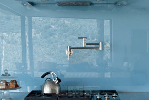 Kitchen with blue glass walls and stove.